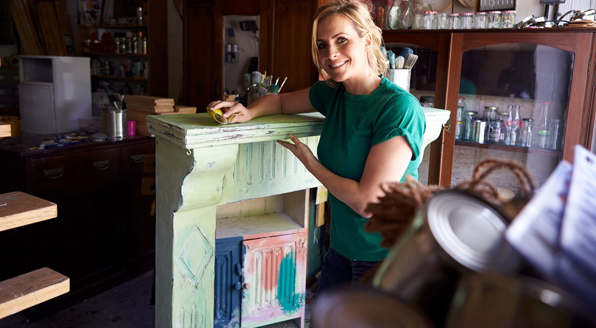 Portrait Of Woman In Workshop Upcycling And Working On Fire Surround